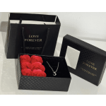 Black gift boxes with red roses and a crescent necklace