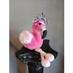 Pink plush flamingo with a striped bow sitting on a black pedestal