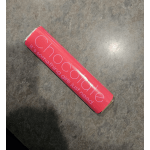 Pink chocolate bar wrapper on a dark surface