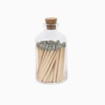 Glass bottle filled with wooden matches and sealed with a cork lid