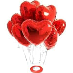 Cluster of red heart-shaped balloons with white strings