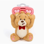 Plush teddy bear holding a pink heart suitcase