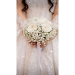 Bride holding a white rose bouquet with baby's breath
