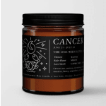 Amber jar candle with a black label reading Cancer