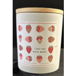 White candle in a jar with a strawberry cream label