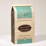 Bag of milk chocolate covered graham crackers standing on a light surface