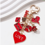 Gold keychain with red heart, rose, and love-themed charms