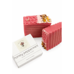Pink soap bars with dried flower petals and a soap box