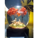 Decorative snow globe with two dogs under orange trees
