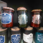 Assorted scented candles in glass jars with cork lids