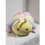 Pastel plush caterpillar toy with a smiling face