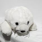 White plush seal toy with black eyes and whiskers
