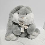 Gray plush bunny with white paws and a ribbon bow