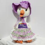 Plush goose doll wearing a purple bonnet and patterned dress
