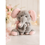Plush gray elephant with pink ears in front of a pastel flower arrangement