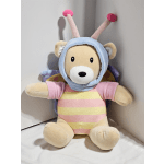 Plush teddy bear in a pastel striped outfit with antennae and wings