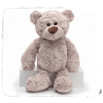 Plush teddy bear sitting on a white box