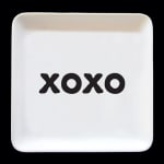 White square dish with the word XOXO in black letters