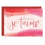Pink greeting card with the words "je t'aime" on the front