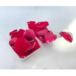 Red rose petals in clear plastic trays on a white surface