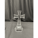 Clear glass cross-shaped stand on a black cloth background