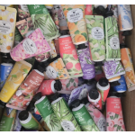 Box filled with assorted hand and body cream tubes and bottles