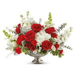Red roses and white flowers in a silver pedestal vase