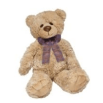 Tan plush teddy bear with a purple plaid scarf sitting against a white background.