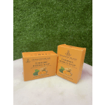 Two orange boxes of turmeric herbal soap on a white surface