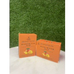 Two orange boxes of mango butter soap on a white surface