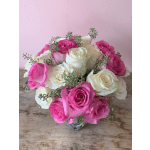 Pink and white roses arranged in a clear glass vase