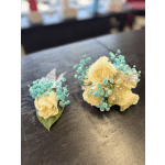 Two small floral arrangements with pale yellow roses and blue filler flowers