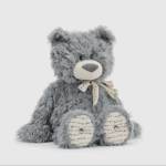 Gray plush teddy bear with a ribbon bow sitting on a white background