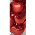 Cluster of red heart-shaped foil balloons