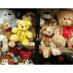 Shelf of plush teddy bears with ribbons and heart pillows