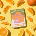 Orange slices surround a greeting card with fruit illustrations and anniversary text.