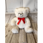 White teddy bear with a red ribbon bow