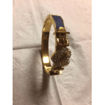 Gold bracelet with a blue enamel band and jeweled clasp