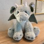 Plush gray dragon with wings and horns sitting on a table