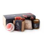 Gift set with a candle, bath items, and a boxed soap
