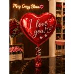 Red heart balloon with "I love you!" text in a flower shop