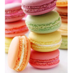 Stacked pastel macarons in pink, green, yellow, and orange