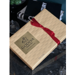 Godiva assorted chocolates in a beige gift box with a red ribbon