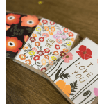 Three floral greeting cards with colorful flower prints and love messages