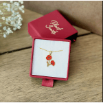 Gold necklace with a red flower pendant in a pink gift box