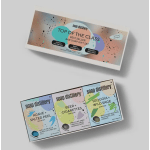 Two boxed soap gift sets with colorful labels on a gray surface