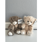 Two plush teddy bears with polka-dot bows sitting side by side