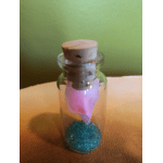 Small glass bottle with a cork stopper, pink ribbon, and blue beads inside