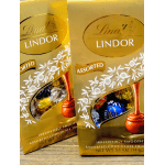 Two Lindt assorted chocolate truffle gift bags on a table