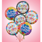 Cluster of colorful Happy Birthday balloons on a pink background